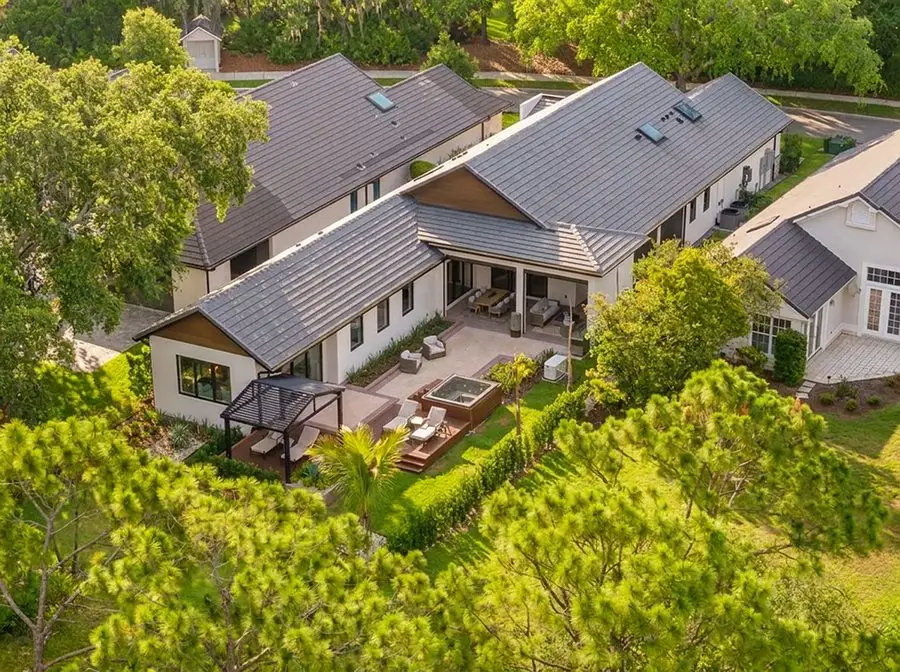 Aerial view of a tile-roof home with a covered patio and pergola, Downtown Orlando roofing service area